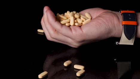 medication, prescription pills being emptied into a person's hand, close-up