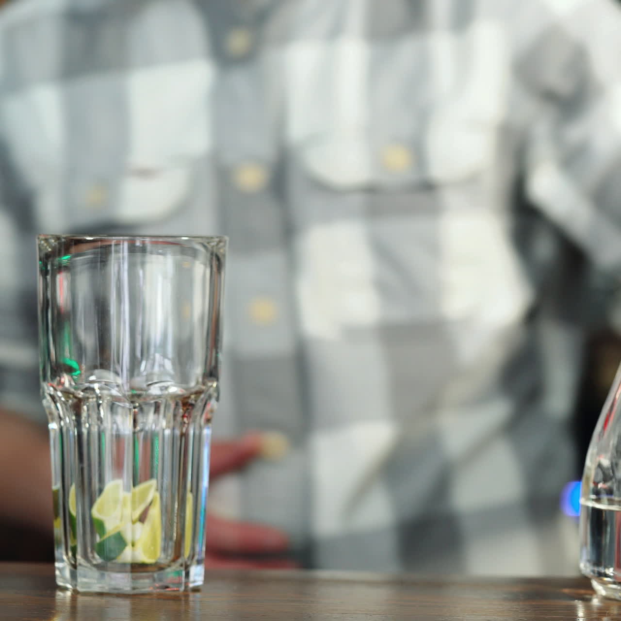 Barman squeezing the fresh lime juice making tasty mojito alcoholic cocktail on the bar counter Sqare video
