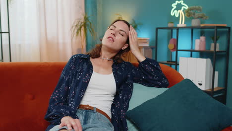 sick ill caucasian woman suffering from headache problem tension and migraine grimacing in pain