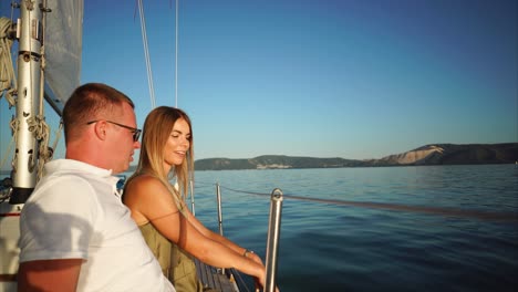couple sailing on a yacht at sunset