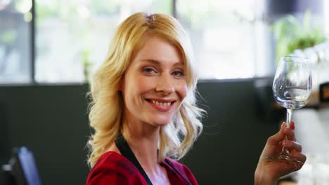 portrait of waitress holding wine glass