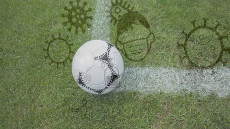 coronavirus concept icons against soccer ball on sports field