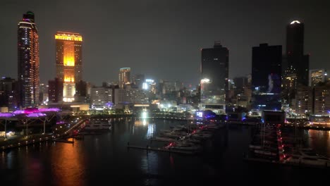 night view of a city skyline with marina