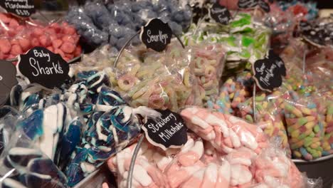 delicious and colorful candies for sale in baskets at candy store