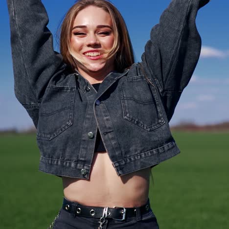 portrait of a cheerful girl. beautiful young woman in jeans jacket jumping and looking on camera on blur nature landscape in spring