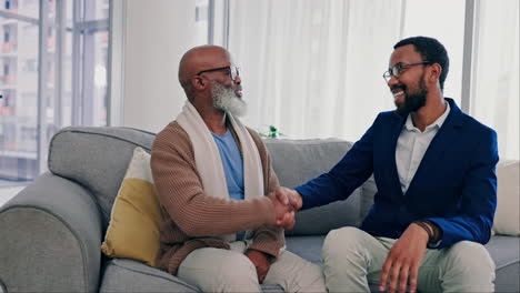 father, son smile and handshake in home