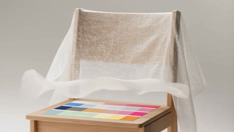 wooden chair with white cloth and color swatches