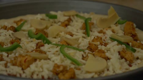 fresh laid pizza slowly rotating with ingredients