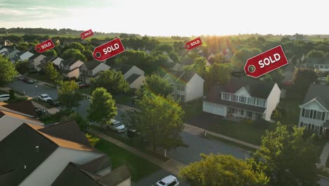 aerial view of a suburban neighborhood at sunset with multiple "sold" signs above houses