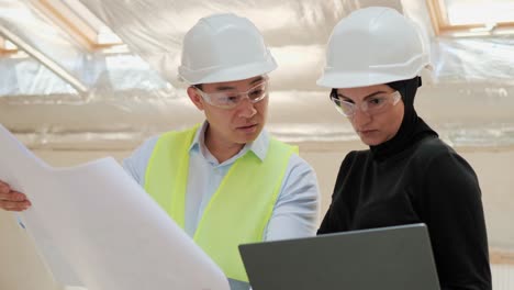 collaboration of arab muslim businesswoman and chinese male entrepreneur. investment buying real estate in japan. asian industry engineer showing project on laptop talking with arab muslim investor.