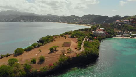 aerial footage of quarantine point peninsula with the mountains of main land grenada in the background