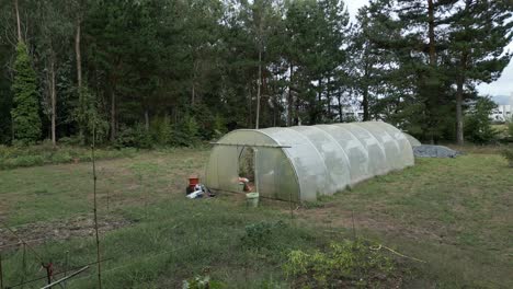 large farming greenhouse manufactured from plastics. farmland scene