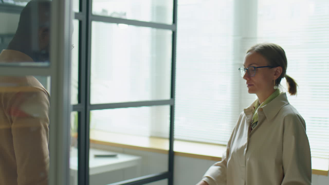 Diverse Colleagues Shaking Hands and Speaking In Office