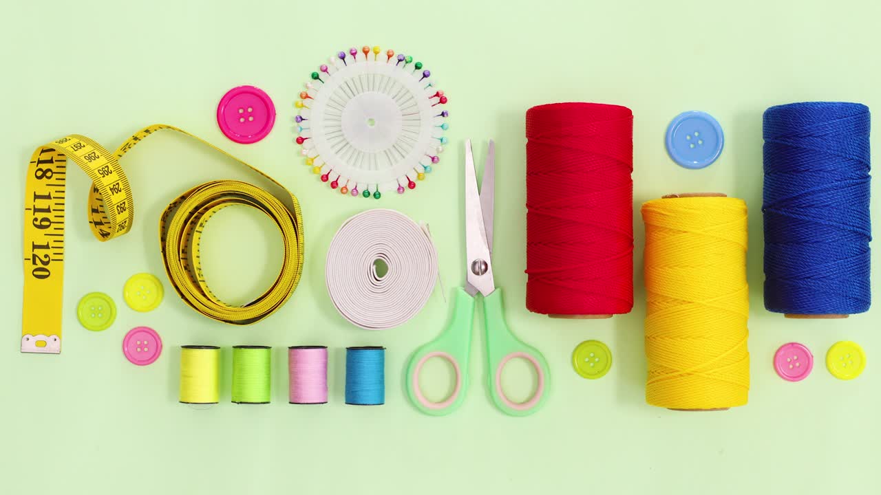 Sewing and knitting threads and other items move on green theme. Stop motion