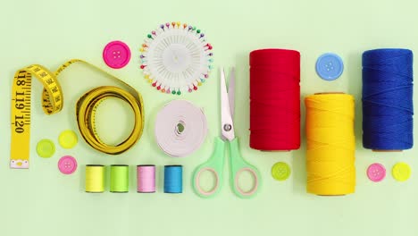 sewing and knitting threads and other items move on green theme. stop motion