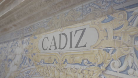 Close up shot of engraved tiles which show a drawing of Cadiz in slowmotion on Plaza de Espana in Sevilla Spain LOG