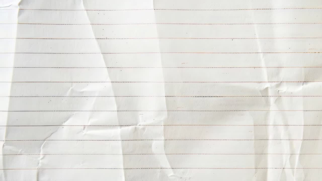 Close-up of a crumpled lined paper texture, shot from above. Ideal for backgrounds in video projects