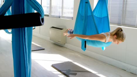 woman doing yoga on hammock 4k