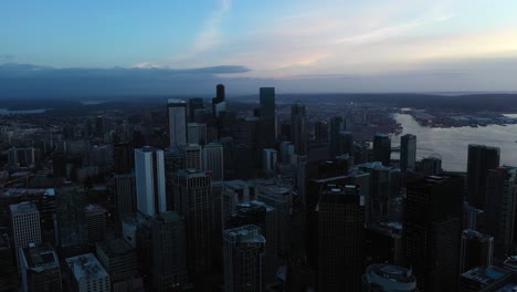 Wide-sweeping-aerial-view-of-Seattle's-downtown-skyscrapers-on-a-cloudy-dark-morning