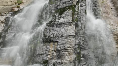 water flowing off cliff at shine falls waterfall in puturino, new zealand