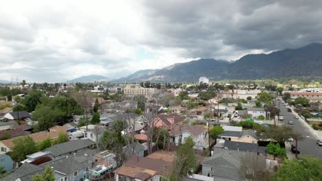 aerial view rising over residential homes in suburban pasadena neighborhood on cloudy day