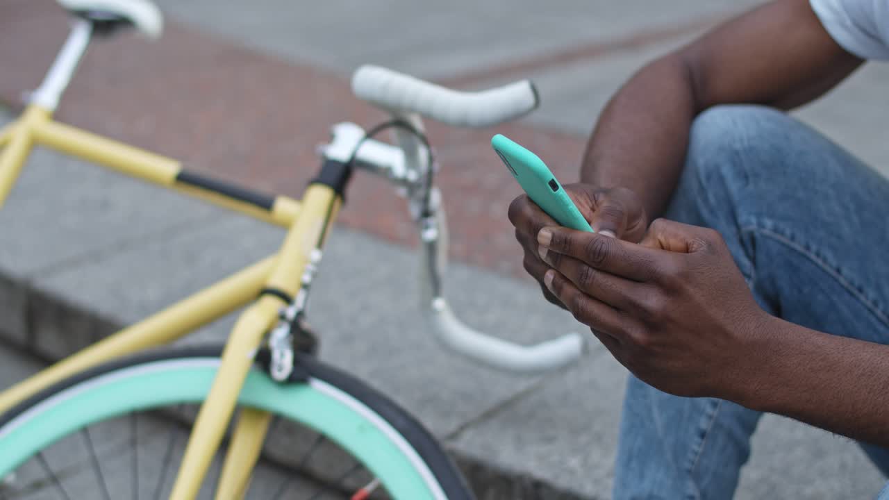 Man with bicycle using mobile phone
