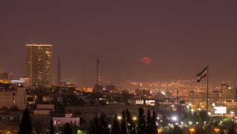 cityscape and lights of houses in city of tehran iran view of modern buildings and high towers in golden time of full moon rise in beautiful night sky