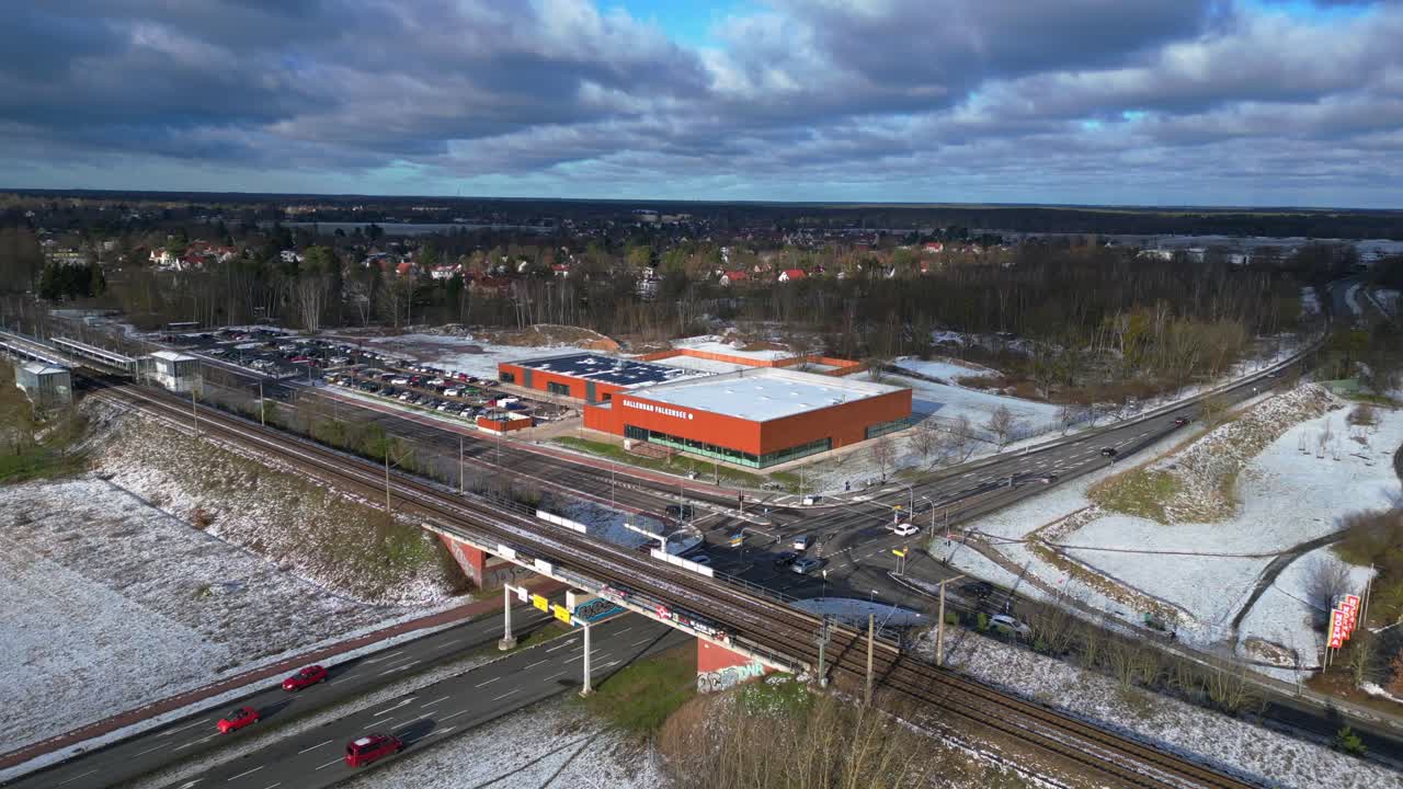 Indoor swimming pool with solar panels surrounded by snow and suburban homes in Falkensee Germany. Fantastic aerial view flight drone shot footage from above