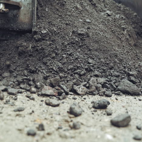 process of pouring hot asphalt out off the heavy machine into the ground. roadworks repaving process. close-up