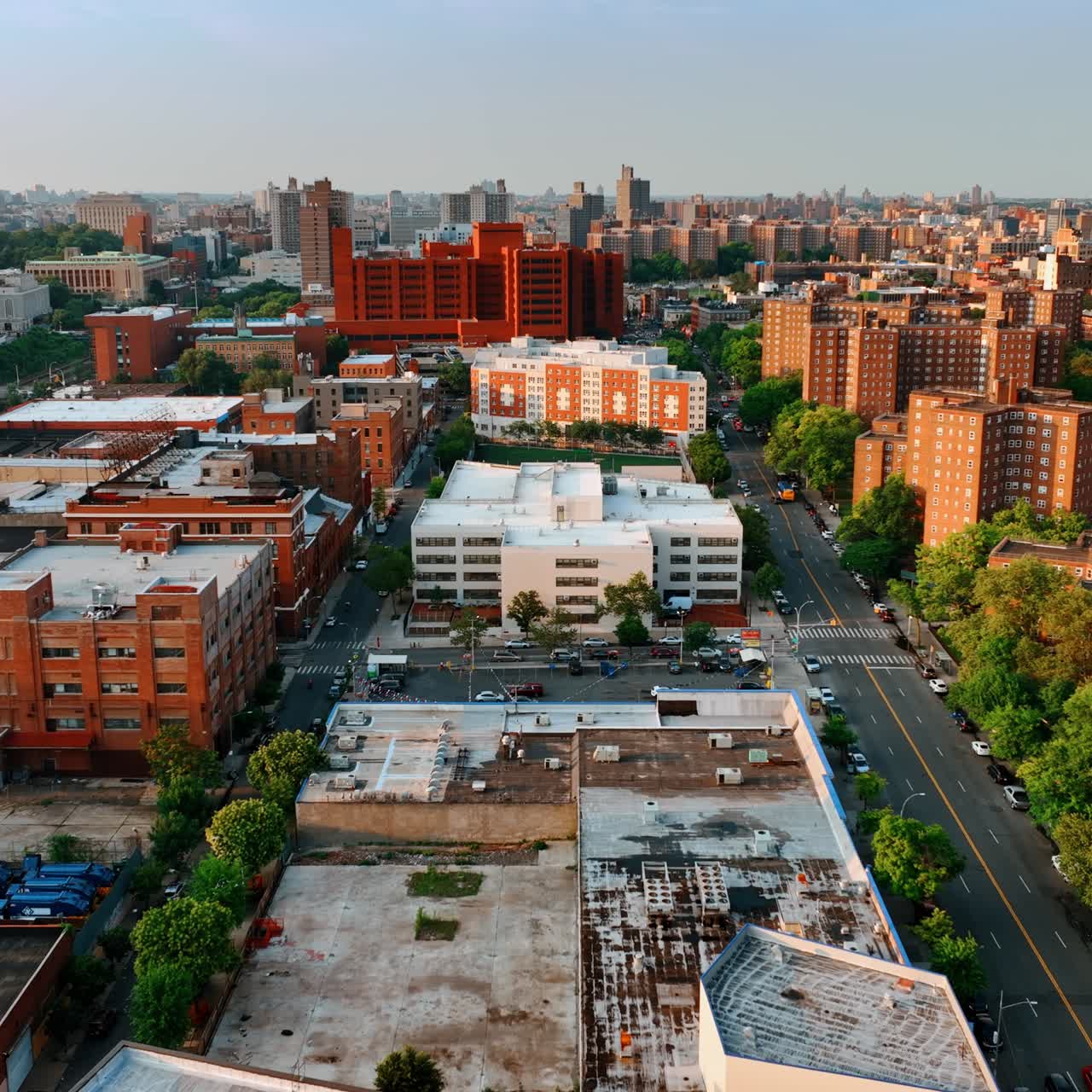 Diverse blocks of flats in the cityscape of New York. Drone footage above the roofs at sunset