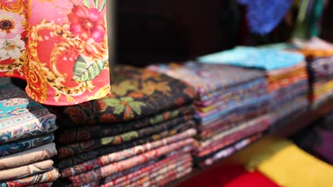 colorful fabrics neatly stacked in a dubai market