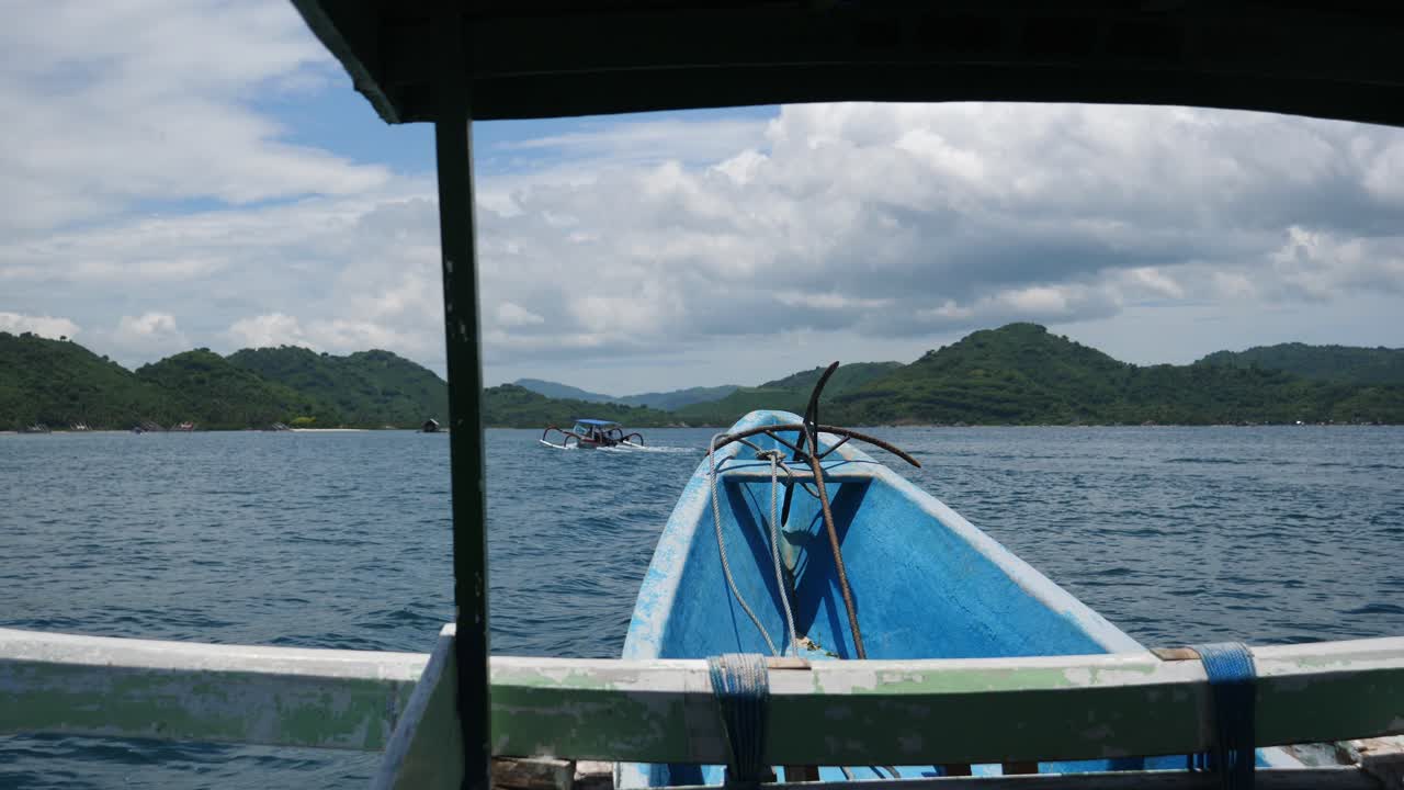 tiro de conducción pov, dentro de un ancla de barco de bomba azul en el frente, vista panorámica de las islas sekotong en indonesia