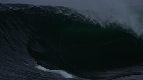 Heavy-winter-swell-barrel-crashes-collapsing-on-tube-with-whitewash-spray-misting-in-slow-motion