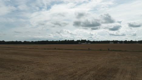 harvested crop field soil in missouri, lamar, aerial drone flyover land, day