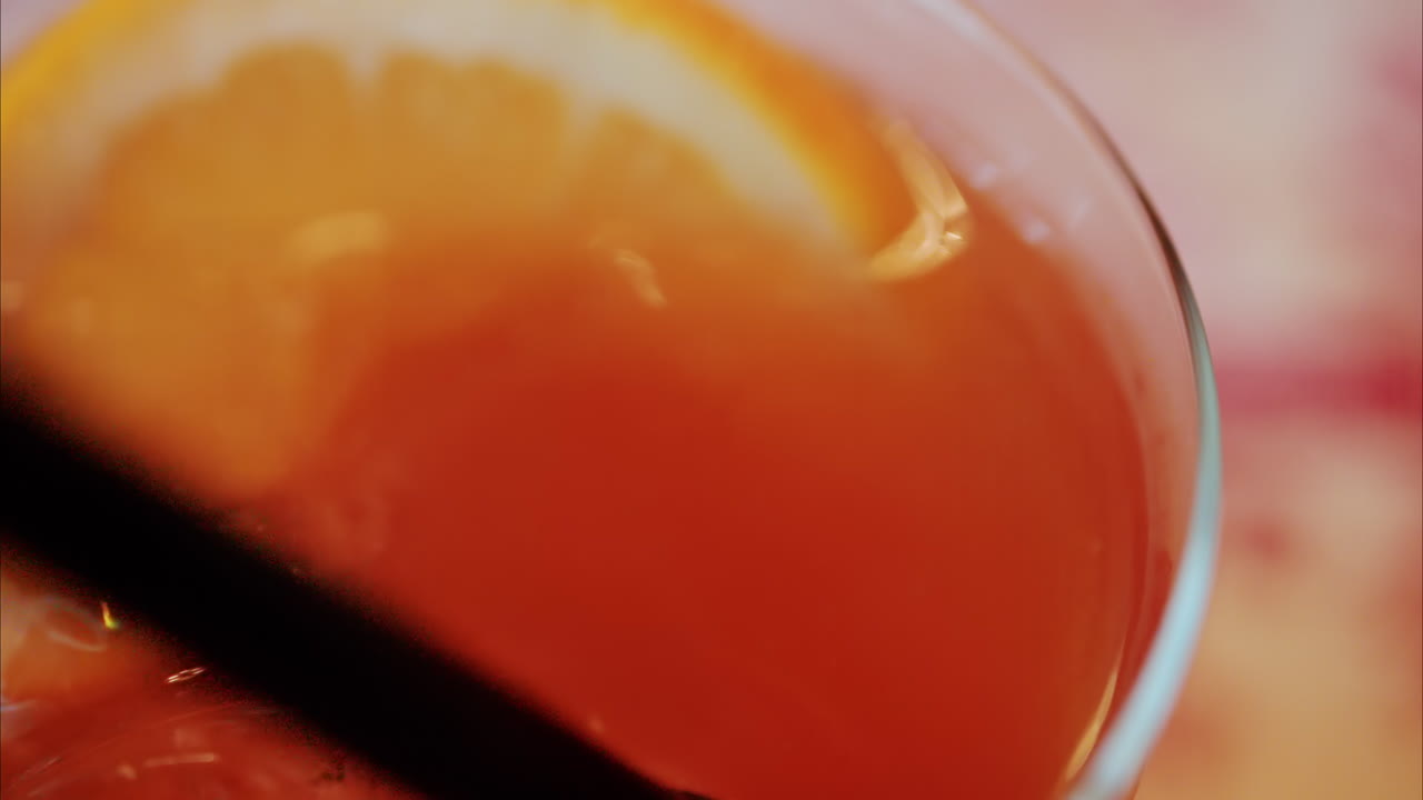 Close up of an orange cocktail on a table at a restaurant