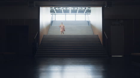 little girl running down empty school staircase alone. child rush to classroom.