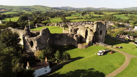 welsh medieval landmark denbigh castle medieval old hill monument ruin tourist attraction aerial rising view across countryside