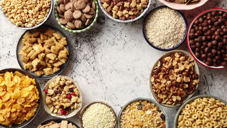 Assortment-of-different-kinds-cereals-placed-in-ceramic-bowls-on-table