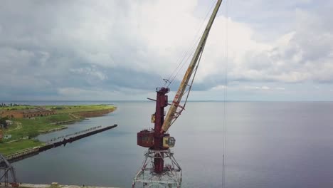 an old abandoned rusty crane in the seaport 01