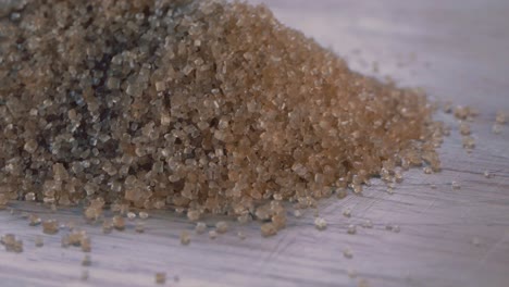 Close-Shot-of-a-Pile-of-Brown-Sugar-Rotating-on-a-Wooden-Board