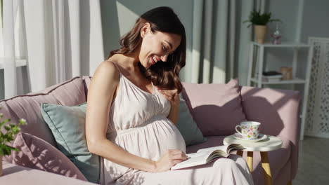 pregnant woman reading on the sofa