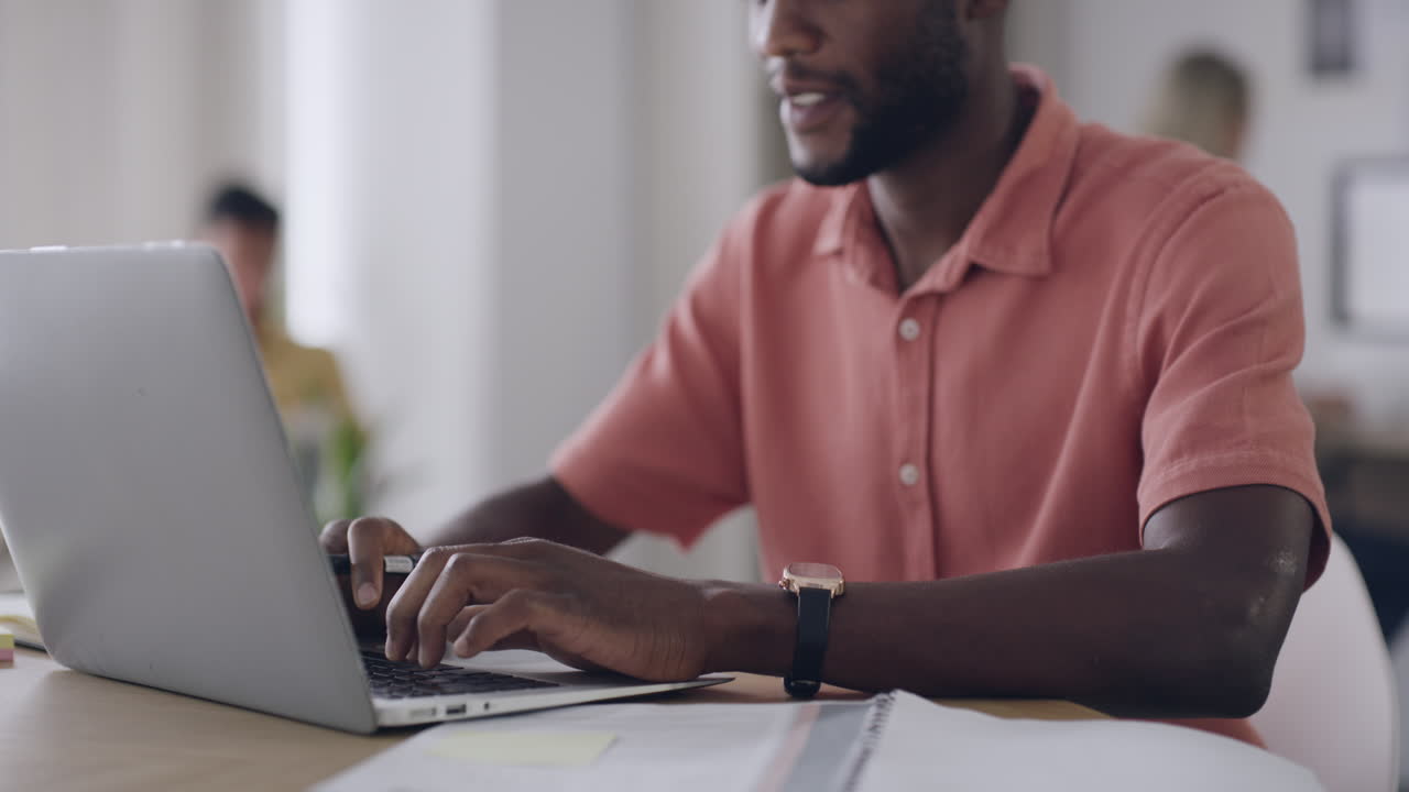 Hand of a young business man typing an email