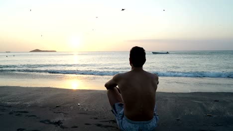 man on the tropical beach looking at sunset, meditate relax, psychological therapy, reflection