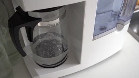 close up of water purifier machine working in the kitchen - high angle, close up