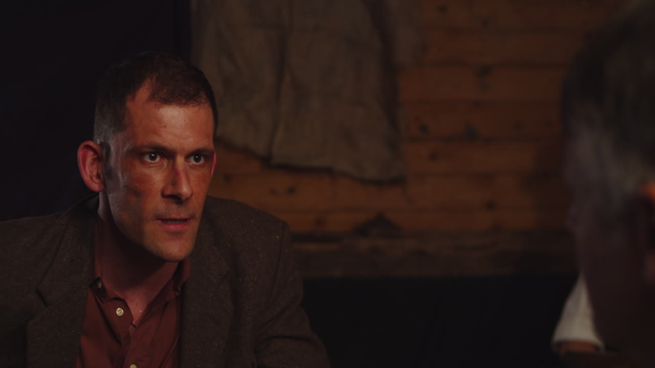 Prohibition era concept - An angry man violently interrogates another man in a gangster hideout