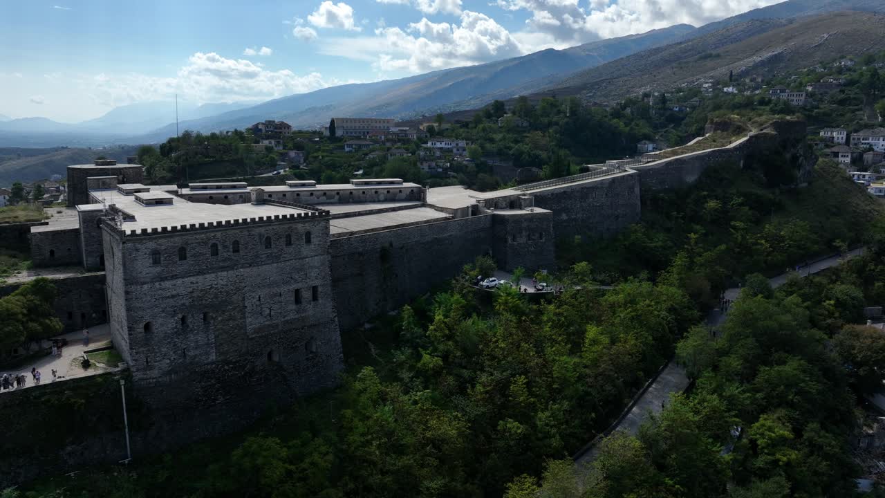 Aerial: Gjirokaster Castle (Fortress) during the day with tourist in Gjirokaster, Albania, establishing drone shot