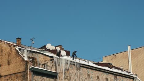 worker on a snowy rooftop