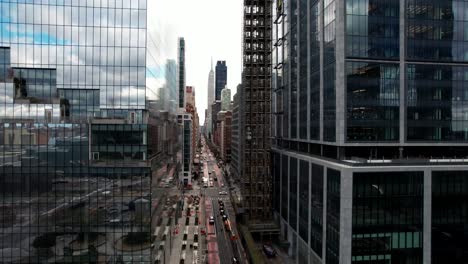 Midtown-Manhattan,-skyscrapers-and-Empire-State-Building-in-New-York-City,-Hudson-Yard,-aerial-rising