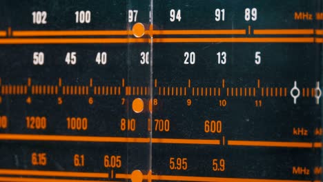 tuning analog radio dial frequency on scale of the vintage receiver