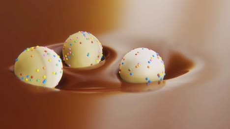 4k video of three sweets in motion in chocolate.